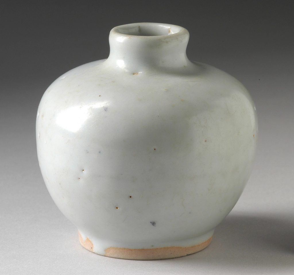 A round white stoneware vase